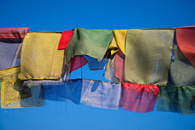 Colorful buddhist prayer flags waving in the wind in himalaya mountains, nepal