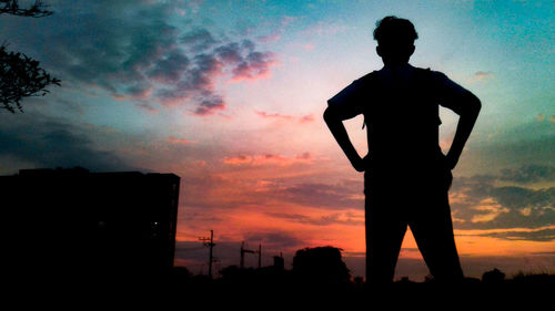 Silhouette man standing against sky during sunset