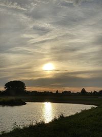 Scenic view of lake against sky during sunset