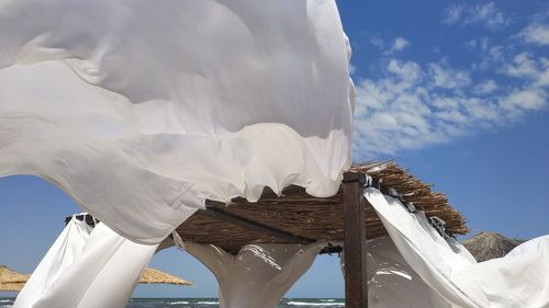 Low angle view of sculpture against cloudy sky