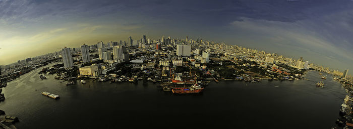 View of modern city lit up at waterfront