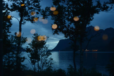 Scenic view of lake against sky at night