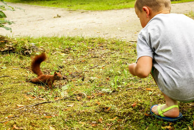 Boy with horse on grass