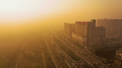 High angle view of illuminated buildings against sky during sunset
