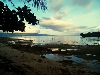 Scenic view of sea against cloudy sky