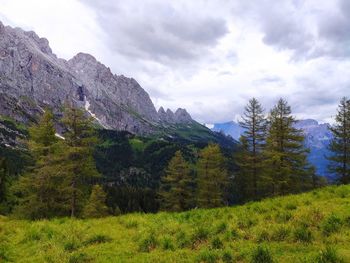Scenic view of mountains against cloudy sky