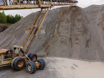 A massive pile of gravel has formed from all the rock transported by this conveyor