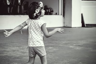 Girl looking away while standing in park