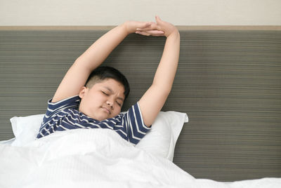 Boy lying on bed