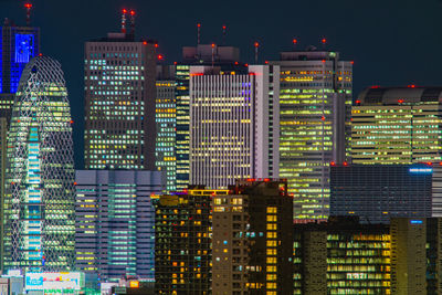 Illuminated buildings in city at night