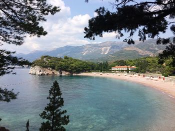 Scenic view of sea and mountains against sky