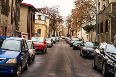 Cars parked on street amidst buildings in city