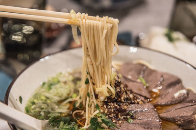 Close-up of hand holding food on table