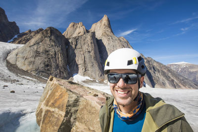 Portrait of climber wearing helmet below mount asgard.