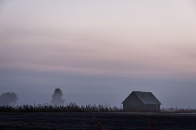 Scenic view of field against sky at sunset