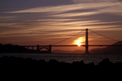 View of suspension bridge at sunset