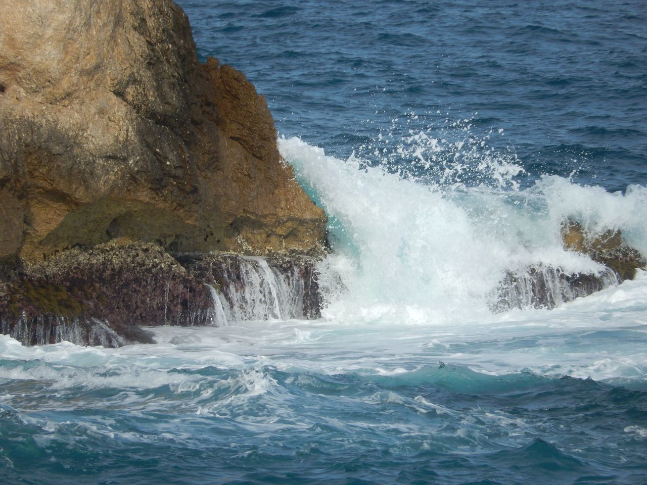 sea, water, motion, beauty in nature, rock, wave, power in nature, solid, rock - object, power, no people, nature, splashing, rock formation, waterfront, day, sport, scenics - nature, land, outdoors, breaking, hitting