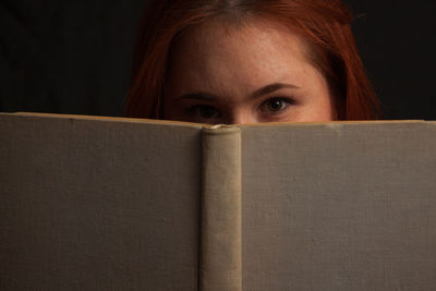 Portrait of woman with open book