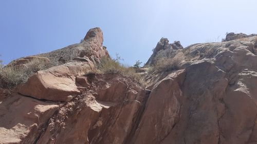 Low angle view of rock formation against sky