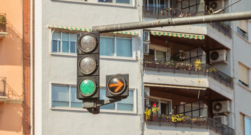 Low angle view of road sign against building