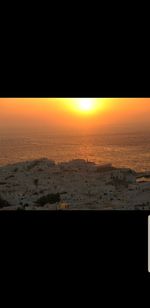 Scenic view of sea against orange sky