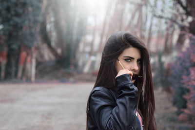 Portrait of beautiful woman against trees