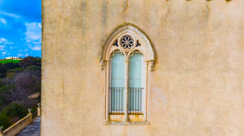 Low angle view of cross on window of building