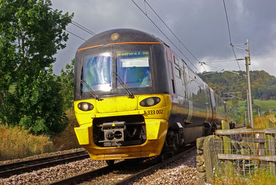 Train on railroad track against sky