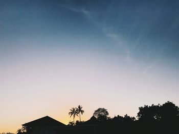 Low angle view of silhouette trees against sky at sunset