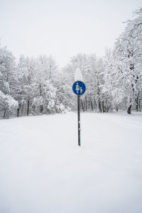 Bare trees on snow covered landscape