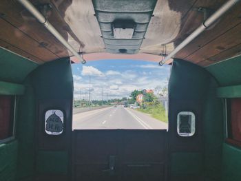 Road seen through train window