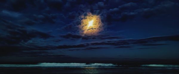 Scenic view of sea against sky at night