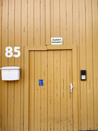 Close-up of text on yellow wall