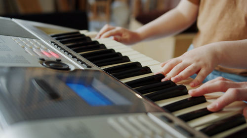 Midsection of woman playing piano