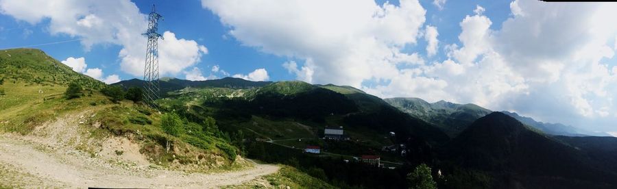 Scenic view of mountains against cloudy sky