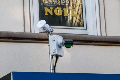 Close-up of electric lamp against wall