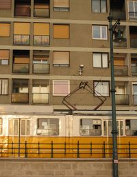 Low angle view of train against building