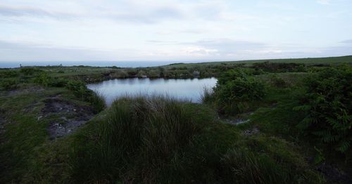 Scenic view of waterfall against sky