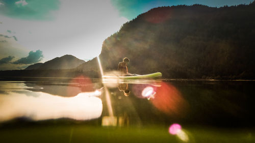 Swan on lake against sky