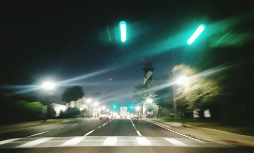 Cars on illuminated road at night