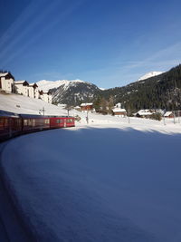 Scenic view of snowcapped mountains against blue sky