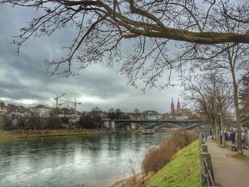 Bridge over river against cloudy sky