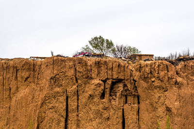 Low angle view of rock formations against sky