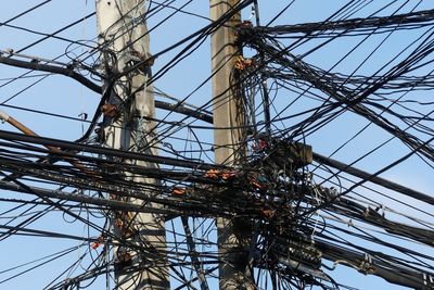 Low angle view of electricity pylon against sky