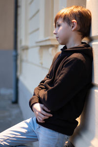 Side view of boy looking at camera