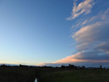 Scenic view of field against sky during sunset