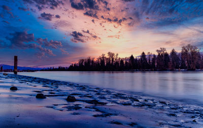 Scenic view of frozen lake against sky during sunset