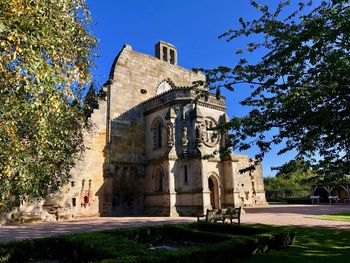 Low angle view of historical building against blue sky