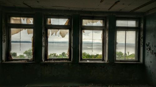 Cloudy sky seen through window of abandoned building
