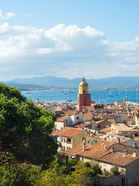 High angle view of cityscape by sea against sky